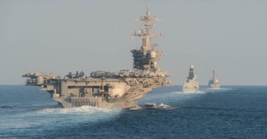 The USS Abraham Lincoln aircraft carrier (L) transits the Strait of Hormuz, Nov. 19, 2019. (AFP Photo)