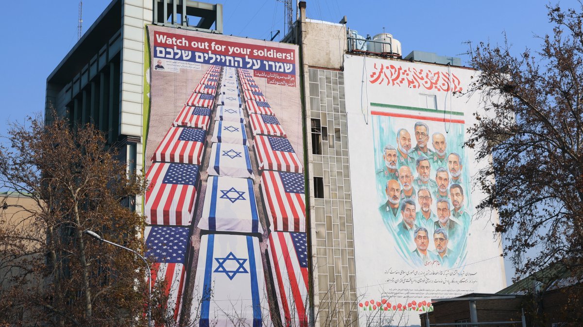 An anti-U.S. and Israeli billboard with a message from the Secretary of the Supreme National Security Council, Ali Larijani, reading "Watch out for your soldiers," following statements by U.S. President Donald Trump supporting anti-government protests, displayed in Palestine Square, Tehran, Iran, Jan. 4, 2026. (EPA Photo)