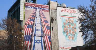 An anti-U.S. and Israeli billboard with a message from the Secretary of the Supreme National Security Council, Ali Larijani, reading "Watch out for your soldiers," following statements by U.S. President Donald Trump supporting anti-government protests, displayed in Palestine Square, Tehran, Iran, Jan. 4, 2026. (EPA Photo)