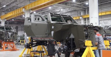 A worker is seen close to an armored vehicle at the production site of Turkish automotive and defense manufacturer Otokar in Sakarya, Türkiye, in this photo released on Jan. 28, 2026. (AA Photo/Otokar Handout)