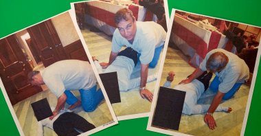 Images from an undated and redacted document released by the U.S. Department of Justice, photographed Saturday, Jan. 31, 2026, show Andrew Mountbatten-Windsor, formerly known as Prince Andrew, leaning over an unidentified person. (AP Photo)