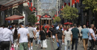 People walk along Istiklal Street, the main shopping street in Istanbul, Türkiye, July 27, 2021. (AP Photo) 