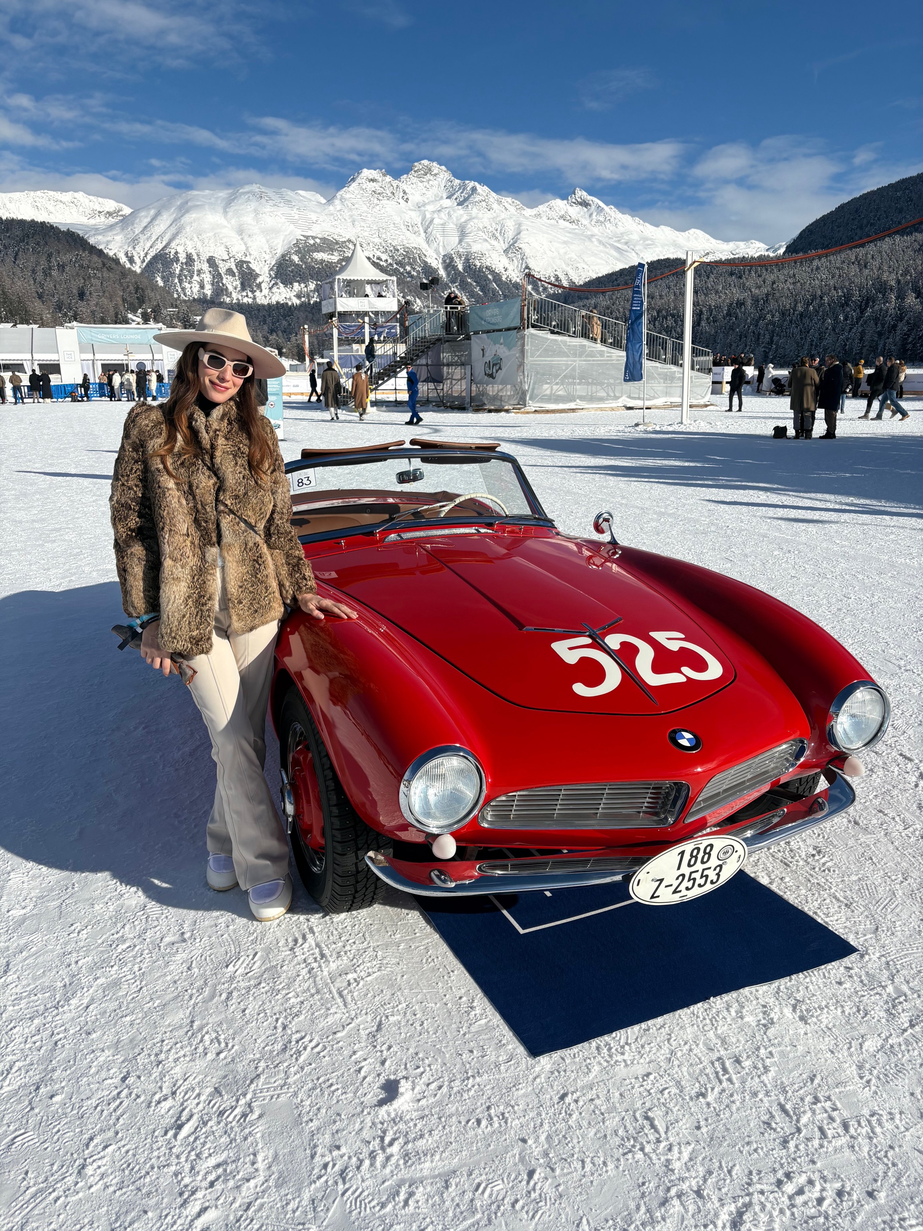 Funda Karayel poses beside one of the iconic cars at the I.C.E. St. Moritz, Switzerland, Jan. 30, 2026. (Photo by Funda Karayel)