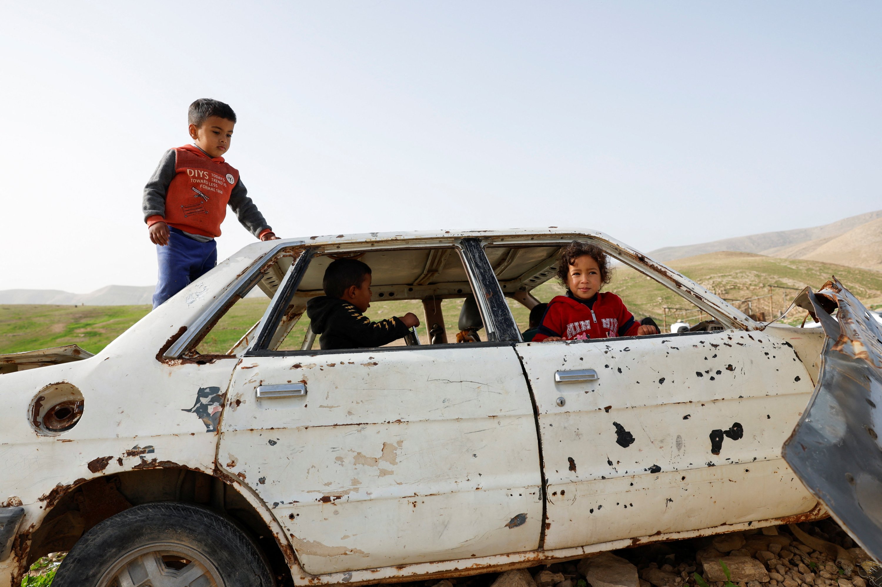 Palestinian children play as members of a Palestinian Bedouin community leave following Israeli settler violence, in Ein al-Auja near Jericho, in the Israeli-occupied West Bank, Jan. 24, 2026. (Reuters Photo)