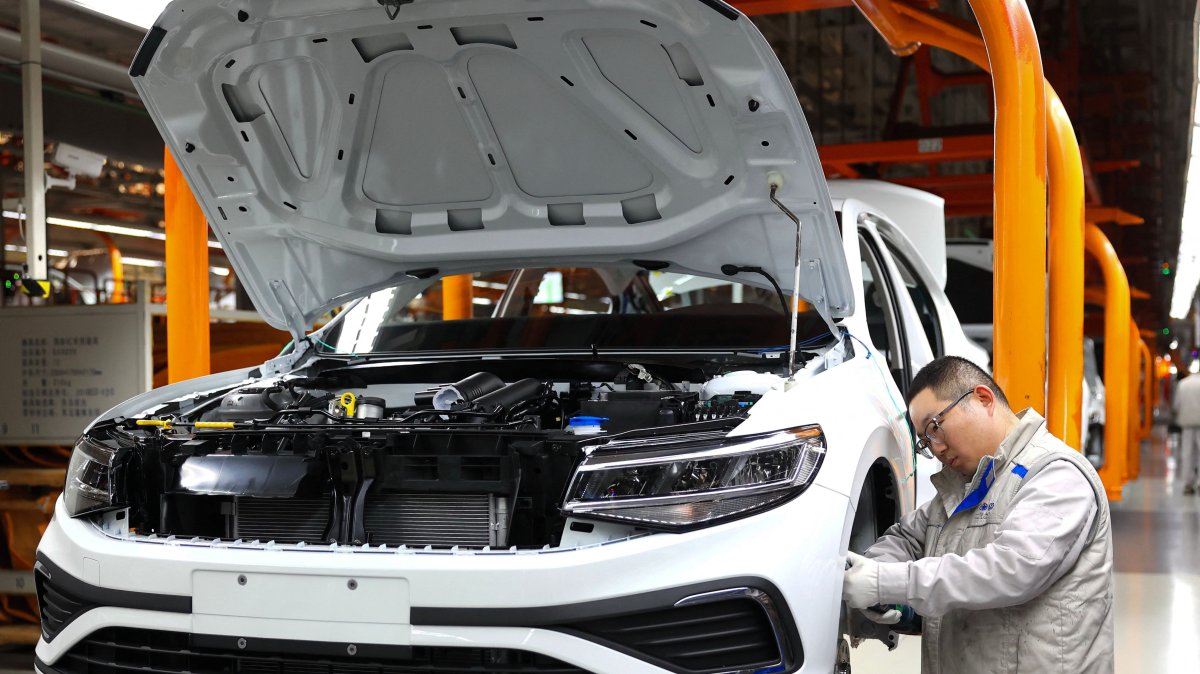 A worker assembles a vehicle on a production line at a FAW-Volkswagen factory in Qingdao, China, Jan. 27, 2026. (AFP Photo)