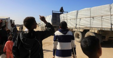Palestinians react as trucks carrying humanitarian aid arrive in Khan Yunis in the southern Gaza Strip, after passing through the Rafah border crossing from Egypt, Feb. 1, 2026. (AFP Photo)