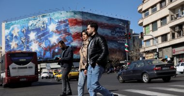 People walk near an anti-U.S. billboard in Tehran, Iran, Jan. 31, 2026. (Reuters Photo)