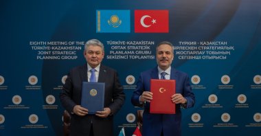 Foreign Minister Hakan Fidan (R) and Kazakh FM Yermek Kosherbayev (L) pose with the cooperation plan, Ankara, Türkiye, Feb. 2, 2026. (AA Photo)
