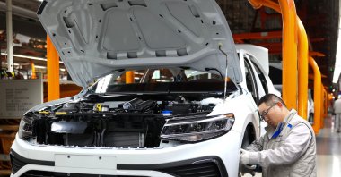 A worker assembles a vehicle on a production line at a FAW-Volkswagen factory in Qingdao, China, Jan. 27, 2026. (AFP Photo)