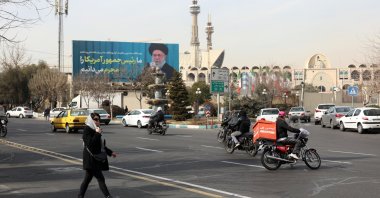 Iranians walk past next to a picture of Iranian supreme leader Ayatollah Ali Khamenei in a street, Tehran, Iran, Feb. 2, 2026. (EPA Photo)