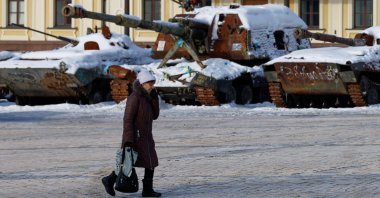 A resident walks past an exhibition of destroyed Russian military vehicles covered with snow during cold weather and often power and heating outages after critical civilian infrastructure was hit by recent Russian missile and drone strikes, amid Russia's attack on Ukraine, in Kyiv region, Ukraine, Feb. 2, 2026. (Reuters Photo)