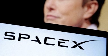 SpaceX's logo and an Elon Musk photo are seen in this illustration, Dec. 19, 2022. (Reuters Photo)