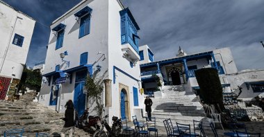 People walk past the Cafe des Nattes in the village of Sidi Bou Said, Tunisia, Jan. 27, 2026. (AFP Photo)