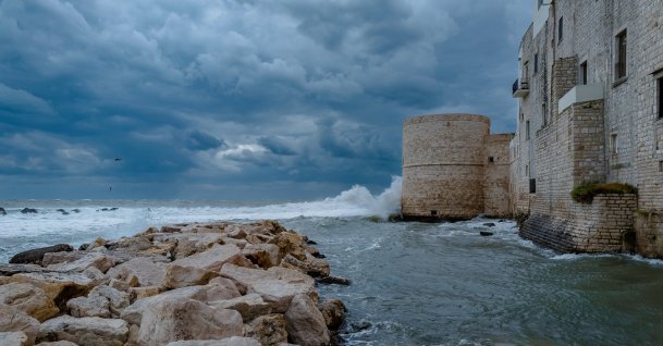 Wind and storm surge occur on Cala Sant'Andrea, in Molfetta, Italy, Oct.3, 2025. Apulia suddenly plunges into winter. Just over 10 days ago, there is still a late summer atmosphere with temperatures close to 30?C, while now heavy clothes and coats are needed to cope with temperatures typical of early December. This dramatic drop in temperatures, accompanied by heavy rain and thunderstorms, is closely linked to a cold snap from Russia, which takes advantage of a rare weather pattern for this time of year, characterized by a powerful anticyclone over Scandinavia capable of activating currents from the east towards the Mediterranean. (Photo by Davide Pischettola/NurPhoto) (Photo by Davide Pischettola / NurPhoto via AFP)