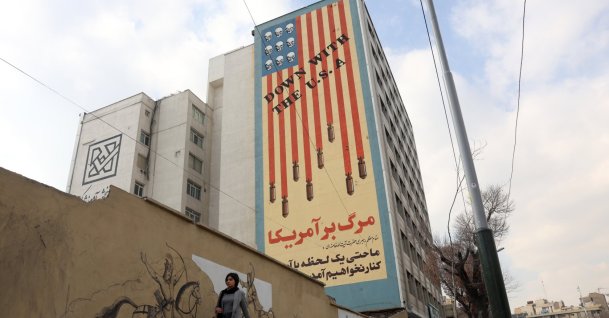 An Iranian woman walks next to an anti-U.S. mural in Tehran, Iran, Jan. 29, 2026. (EPA Photo)