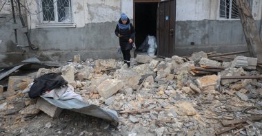 A resident leaves the apartment building hit by a Russian drone strike, amid Russia's attack on Ukraine, in Odesa region, Ukraine, Feb. 4, 2026. (Reuters Photo)