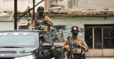 Members of the YPG terrorist group wait for the arrival of the security forces of the Syrian government during the curfew, Qamishli, Syria, Feb. 3, 2026. (Reuters Photo)
