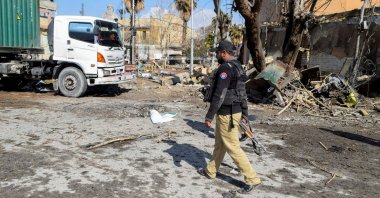 A police officer walks past damage at the site, after militant attacks, in Quetta, Pakistan, Feb. 1, 2026. (Reuters Photo)