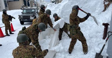 Japan Ground Self-Defense Forces carry out snow removal work in a town within Aomori Prefecture, Japan, Feb. 3, 2026. (AFP Photo)