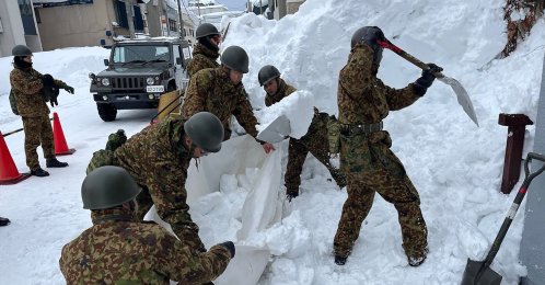 Japan Ground Self-Defense Forces carry out snow removal work in a town within Aomori Prefecture, Japan, Feb. 3, 2026. (AFP Photo)