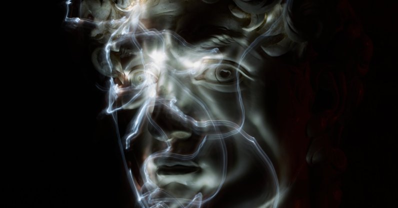 Stefania Terre, who is blind, uses a small light on her fingers while touching a life-size reproduction of the head of Michelangelo's David as she poses for a long-exposure photograph at the Omero Tactile Museum, Ancona, Italy, Jan. 15, 2026. (AP Photo)