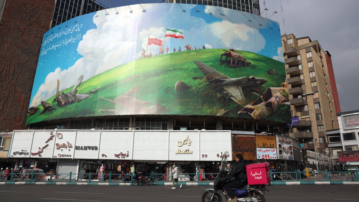 Iranians drive past a new anti-U.S. billboard in Valiasr Square, Tehran, Iran, Feb. 5, 2026. (EPA Photo)