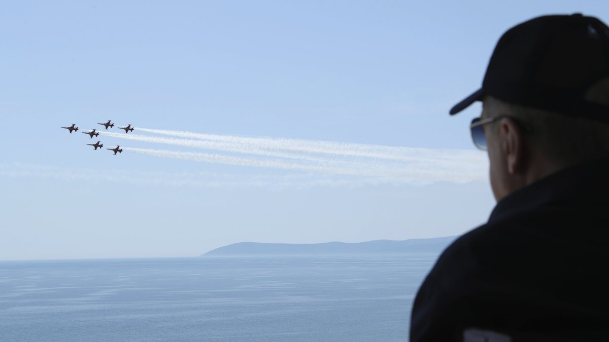 President Recep Tayyip Erdoğan watches jet fighters fly past during the final day of military exercises that were taking place on the Aegean coast, in Seferihisar near Izmir, Türkiye, June 9, 2022. (AP Photo)