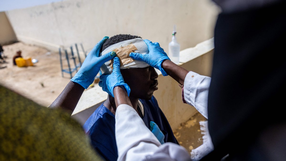Mahamat Hamid Abakar, 33, who suffered head and leg injuries during a drone attack on the vehicle he was traveling in near Um Baru, Sudan, is being treated by nurses at the hospital in Tine, Wadi Fira, Chad, Jan. 30, 2026. (AFP Photo)