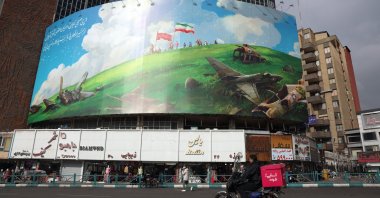 Iranians drive past a new anti-U.S. billboard in Valiasr Square, Tehran, Iran, Feb. 5, 2026. (EPA Photo)