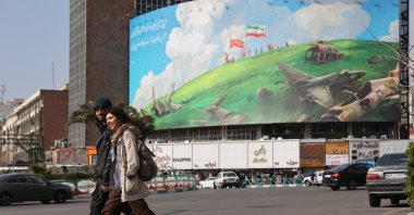 People walk past an anti-U.S. billboard on a street in Tehran, Iran, Feb. 5, 2026. (Reuters Photo)