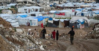 Children walk past tents and makeshift shelters in the Bureij refugee camp in the central Gaza Strip, Feb. 3, 2026. (AFP Photo)