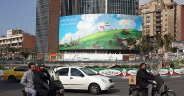 Iranians drive past a new anti-U.S. billboard at Valiasr Square in Tehran, Iran, Feb. 5, 2026. (EPA Photo)