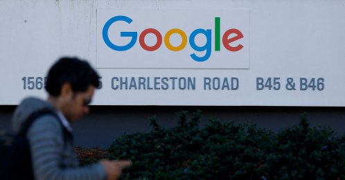 A pedestrian walks by a sign at Google headquarters in Mountain View, California, U.S., Feb. 4, 2026. (AFP Photo)
