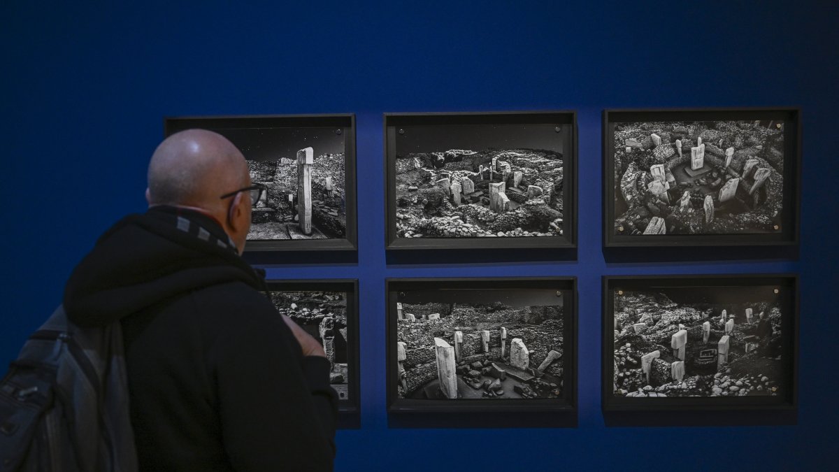 A visitor views photos of Göbeklitepe at the “Building Community: Göbeklitepe, Taş Tepeler and Life 12,000 Years Ago” exhibition, Berlin, Germany, Feb. 5, 2026. (AA Photo)