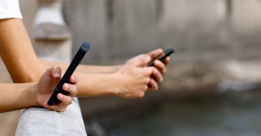 Two 15-year-olds use social media on their mobile phones, Arinaga, the island of Gran Canaria, Spain, Feb. 3, 2026. (Reuters Photo)