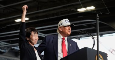 U.S. President Donald Trump (R), with Japanese Prime Minister Sanae Takaichi, speaks to members of the military aboard the USS George Washington, an aircraft carrier docked at an American naval base, Yokosuka, Japan, Oct. 28, 2025. (AP Photo)