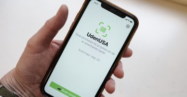 A close-up shows a mobile phone displaying the app UdenUSA, which translates to Without USA in Danish, Copenhagen, Denmark, Jan. 21, 2026.  (EPA Photo)