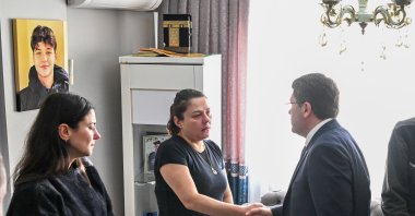 Justice Minister Yılmaz Tunç (R) visits the parents of Atlas Çağlayan (on the picture on the wall) murdered by a 15-year-old, Istanbul, Türkiye, Feb. 7, 2026. (DHA Photo)