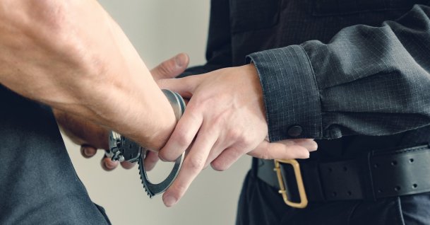 Handcuffs are placed on the wrists of the detained man. (Shutterstock Photo)