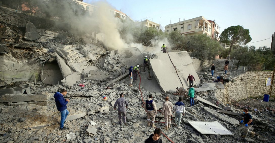 Civil Defense workers and civilians inspect a destroyed building following an Israeli airstrike in Ain Qana village, in southern Lebanon, Feb. 2, 2026. (EPA Photo)