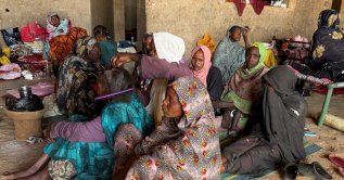 A displaced woman from Dalanj braids her grandmother's hair at a displacement registration center in El Obeid, North Kordofan State, Sudan, Jan. 15, 2026. (Reuters File Photo)