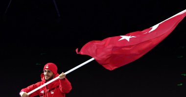 Flagbearer Furkan Akar leads the delegation of Türkiye during the Opening Ceremony of the Milano Cortina 2026 Winter Olympic Games, Milan, Italy, Feb. 6, 2026. (EPA Photo)
