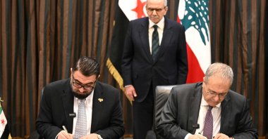 Syria's Justice Minister Mazhar al-Wais (L) and Lebanese Deputy Prime Minister Tarek Metri (R), signing a prisoner exchange agreement, as Lebanese Prime Minister Nawaf Salam looks on at the Grand Serail (Government Palace), Beirut, Lebanon, Feb. 6, 2026. (Photo AFP)