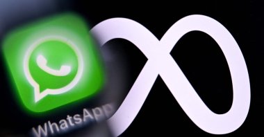 This illustration shows the logos of U.S. instant messaging software WhatsApp and Meta Platforms displayed on a smartphone's screen, in Frankfurt, Germany, Dec. 1, 2025. (AFP Photo)