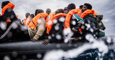 Migrants onboard a crowded rubber boat wait for a rescue ship in the search-and-rescue zone off the international waters of Libya, Jan. 16, 2026. (AFP Photo)