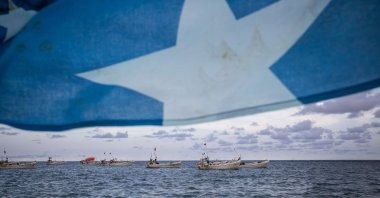 A Somali flag flies from a tourist boat as people swim and spend time on Lido beach, Mogadishu, Somalia, April 25, 2025. (Getty Images)