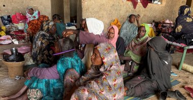 A displaced woman from Dalanj braids her grandmother's hair at a displacement registration center in El Obeid, North Kordofan State, Sudan, Jan. 15, 2026. (Reuters File Photo)