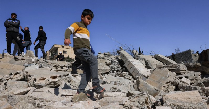 A Palestinian boy walks along the debris from homes and shops demolished by Israeli forces in Beit Aawa, Hebron, Israeli-occupied West Bank. Feb. 5, 2026. (AFP Photo)