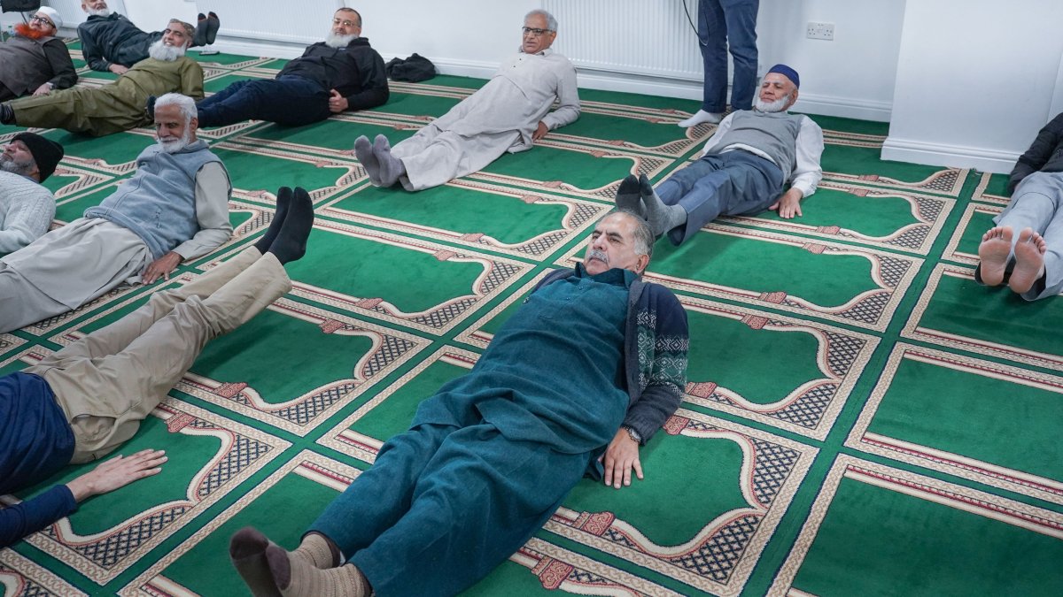 After prayers, older men do pilates at UK mosque in Bradford