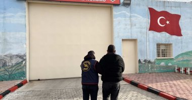 Turkish gendarmerie officers escort a suspect wanted in connection with a FETÖ-related case, Afyonkarahisar, western Türkiye, Feb. 6, 2026. (IHA Photo)